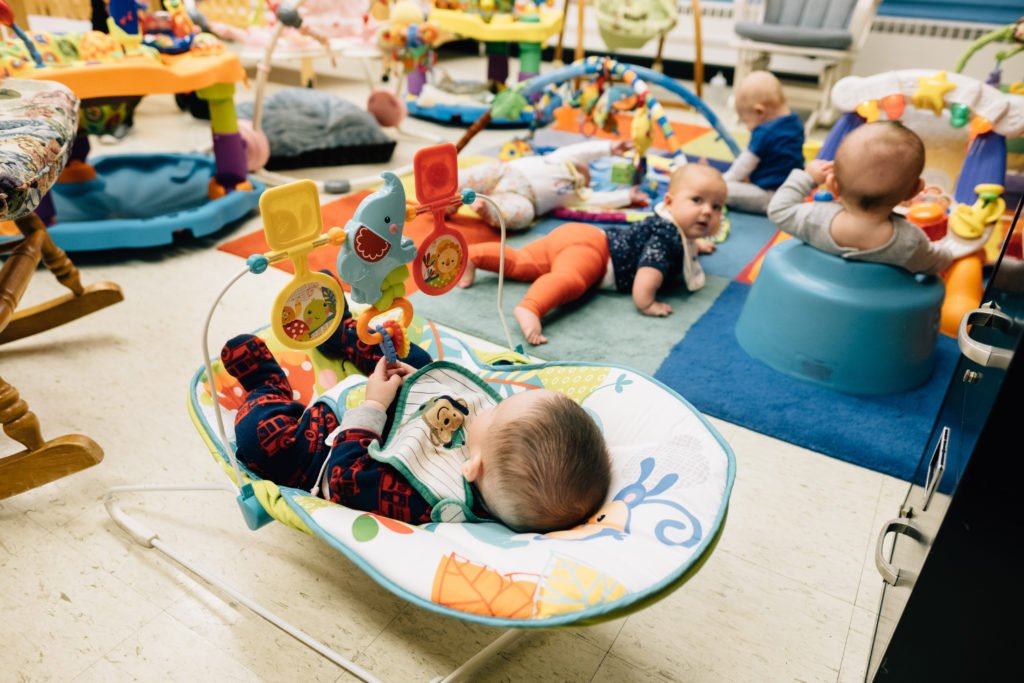 Babies on carpet and in bouncers.