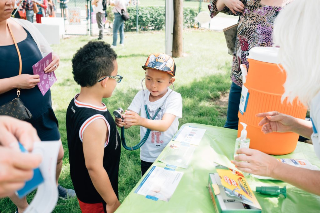 Two young children playing with a stethoscope | gender play