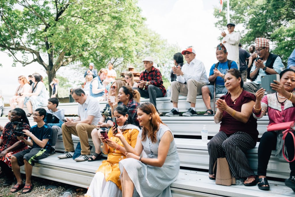 Parents and caregivers sitting on bleachers | self-care for parents and caregivers