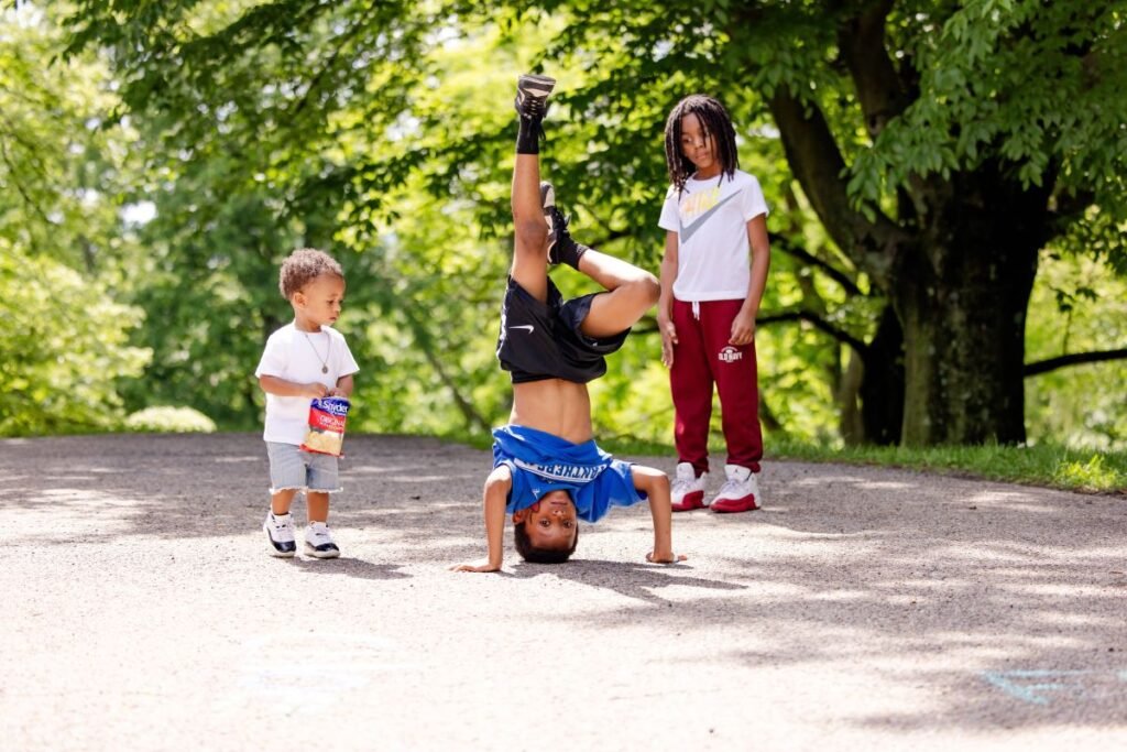 One child doing a head stand and two other children standing by intrigued | 8 Ways to Encourage Math Learning During Risky Outdoor Play