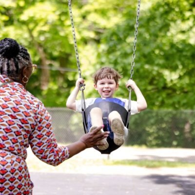 A parent pushing their child on a swing | What to Know About Brain Science and Guided Play